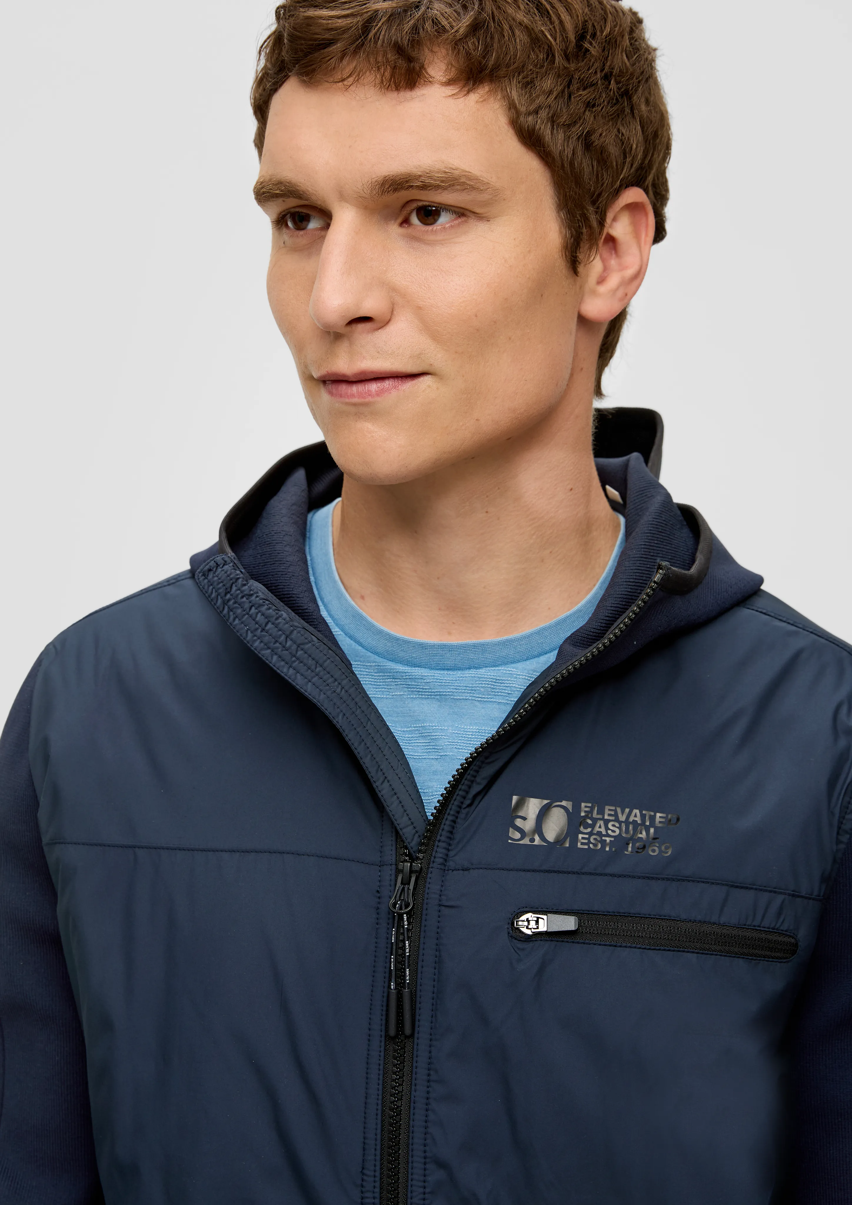 Nylon jacket with knit sleeves and a hood