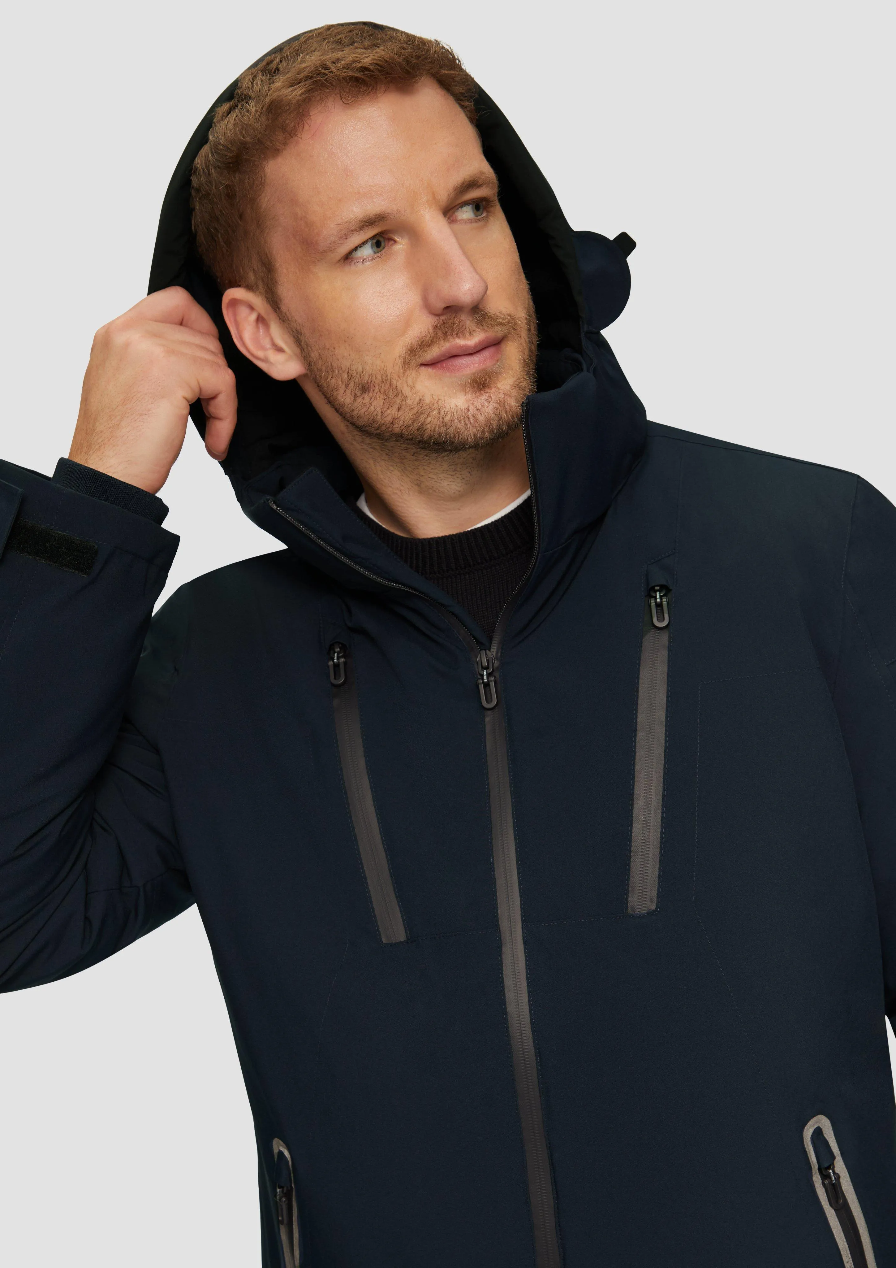 Water-resistant jacket with a hood and zip details